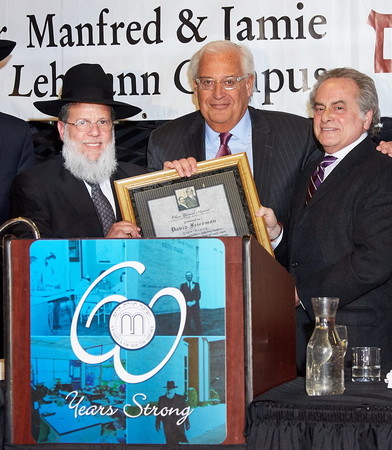 Ambassador to Israel-designee David Friedman accepts YOSS&rsquo; Ohev Yisrael Award in memory of his father, Rabbi Morris Friedman, a&rdquo;h. He is flanked by Rabbi Mordechai Kamenetzky, YOSS rosh yeshiva.