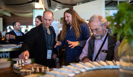 Inside the annual CannaTech medical marijuana innovation conference in Tel Aviv on March 20, Moshe Ihea (center), founder and CEO of Israel-based Cannabliss.