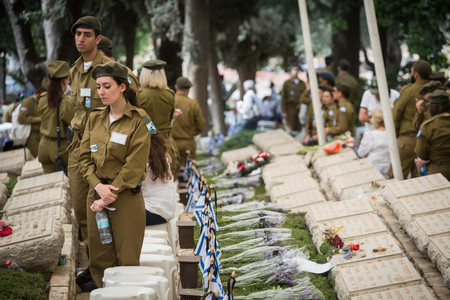 Family members, Israeli soldiers, and veteran fighters,  stand by the graves of  Palmach fighters who died in battles to open the way to Jerusalem during the 1948 War, at Kiryat Anavim military cemetery during Yom Ha&rsquo;Zikaron, Israel's Memorial Day.