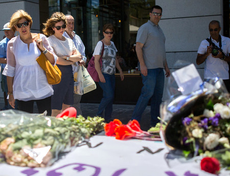Israelis visit and light candles at a makeshift memorial at the site of a shooting at Sarona Market in Tel Aviv, on June 10, 2016.