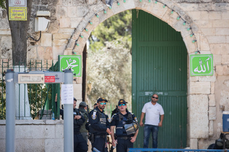 Israeli security officers stand near a newly installed metal detector at one of the entrance gates to the Temple Mount on July 17.