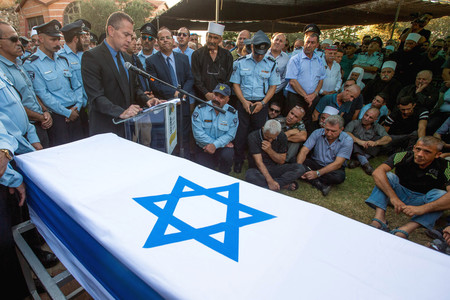 Public Security Minister Gilad Erdan speaks at the funeral of Druze police officer Kamil Shnaan in the northern village of Hurfeish.