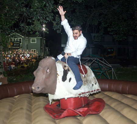 Machi Reichenberg, from Jerusalem, rides a mechanical bull.