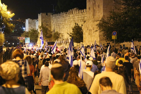 Thousands of Jews marched in a demonstration organized by Women in Green around the walls of Jerusalem's Old City, calling the state to make the Temple Mount under Israeli control and allowing Jews to pray there, on the eve of Tisha B'Av, July 31, 2017.