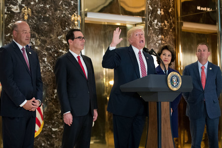 President Trump speaks with reporters in the lobby of Trump Tower on Tuesday, Aug. 15. Standing alongside him, from left: Director of the National Economic Council Gary Cohn, Treasury Secretary Steve Mnuchin, Transportation Secretary Elaine Chao and Director of the Office of Management and Budget Mick Mulvaney. He fielded questions about his comments on the events in Charlottesville, Virginia, and white supremacists.