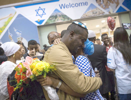 Ethiopian Falash Mura are greeted by family members as they arrive at Ben Gurion airport on June 06.