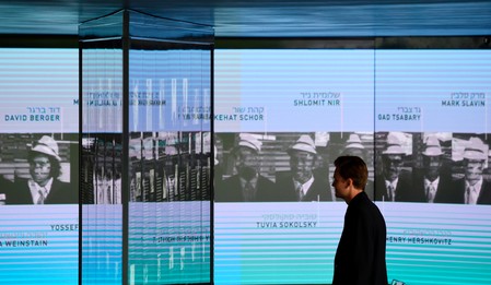 A visitor looking at the portraits of the Israeli Olympians murdered at the 1972 Munich games at a new memorial in the German city, Sept. 6, 2017.
