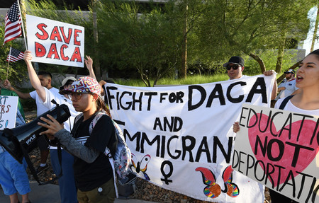 Immigrants and DACA supporters rally across the street from the Trump International Hotel &amp; Tower in Las Vegas on Sept. 10.