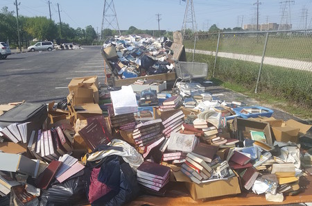 Piles of ruined books from United Orthodox Synagogues of Houston. The congregation lost many of its prayer books and replenished them through donations.