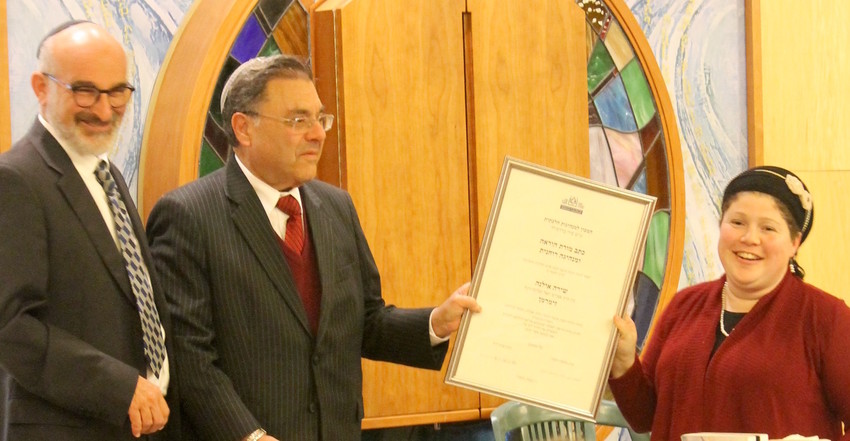 Rabbi Shuki Reich, left, seminary head of the Susi Bradfield Women&rsquo;s Institute of Halakhic Leadership, and Rabbi Shlomo Riskin, chancellor of Ohr Torah Stone, present Rabbanit Shira Zimmerman with her certification as a spiritual leader and arbiter of Jewish law at a ceremony in Jerusalem on Jan. 3.