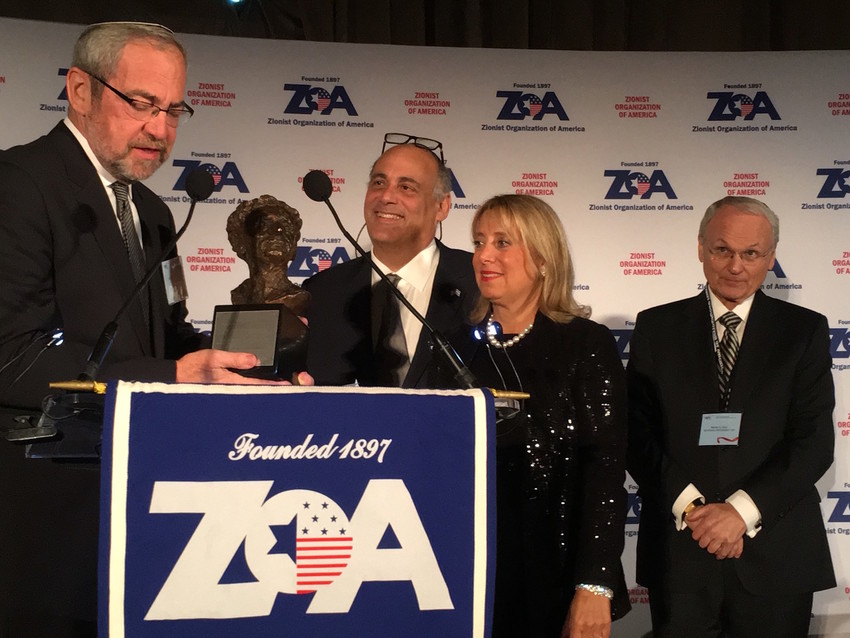 Rabbi Kenneth Hain of Congregation Beth Sholom in Lawrence presents the Louis D. Brandeis award to Shalom and Iris Maidenbaum at Sunday night&rsquo;s ZOA gala, as ZOA President Morton Klein looks on.
