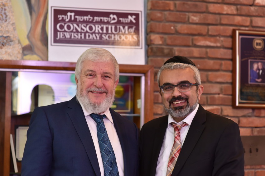 Rabbi Dr. Heshy Glass (left), chairman of the Consortium of Jewish Day Schools, and Rabbi Yaakov Sadigh, principal of HANC&rsquo;s Samuel and Elizabeth Bass Golding Elementary School.