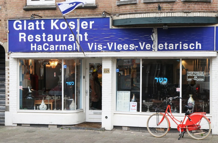 A man waving a Palestinian flag smashed the windows of the HaCarmel kosher restaurant in Amsterdam on Dec. 7.