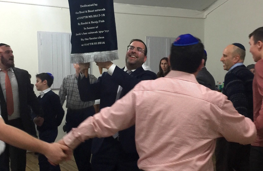 Rabbi Dovid Kupchik, Menahel K&ndash;8, is pictured dancing with the Torah, which will be housed at a Navy base in Ashdod.