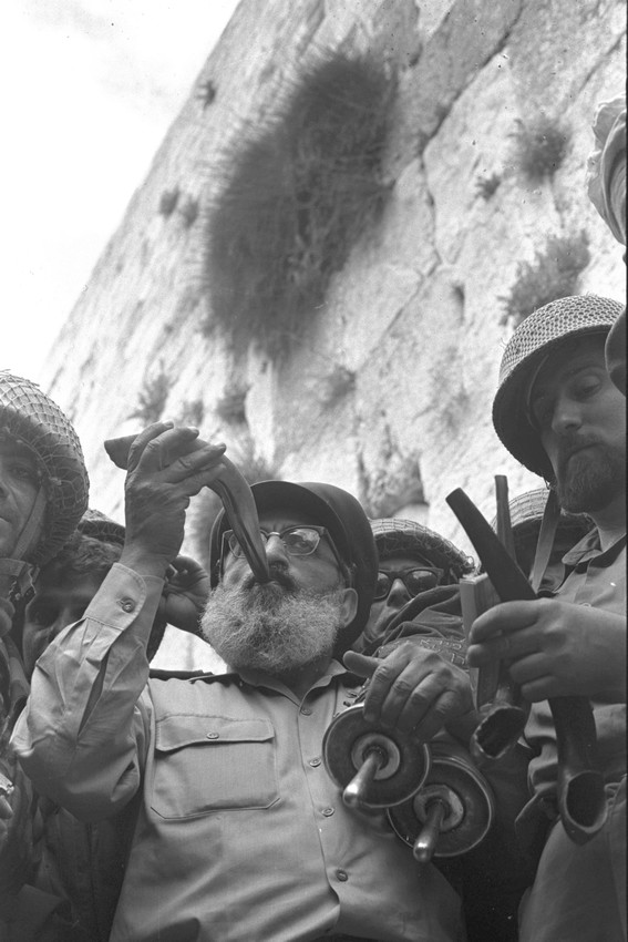 Back home after the Six Day War: Army Chief Chaplain Rabbi Shlomo Goren, surrounded by IDF soldiers, blows the shofar in front of the Kotel in Jerusalem