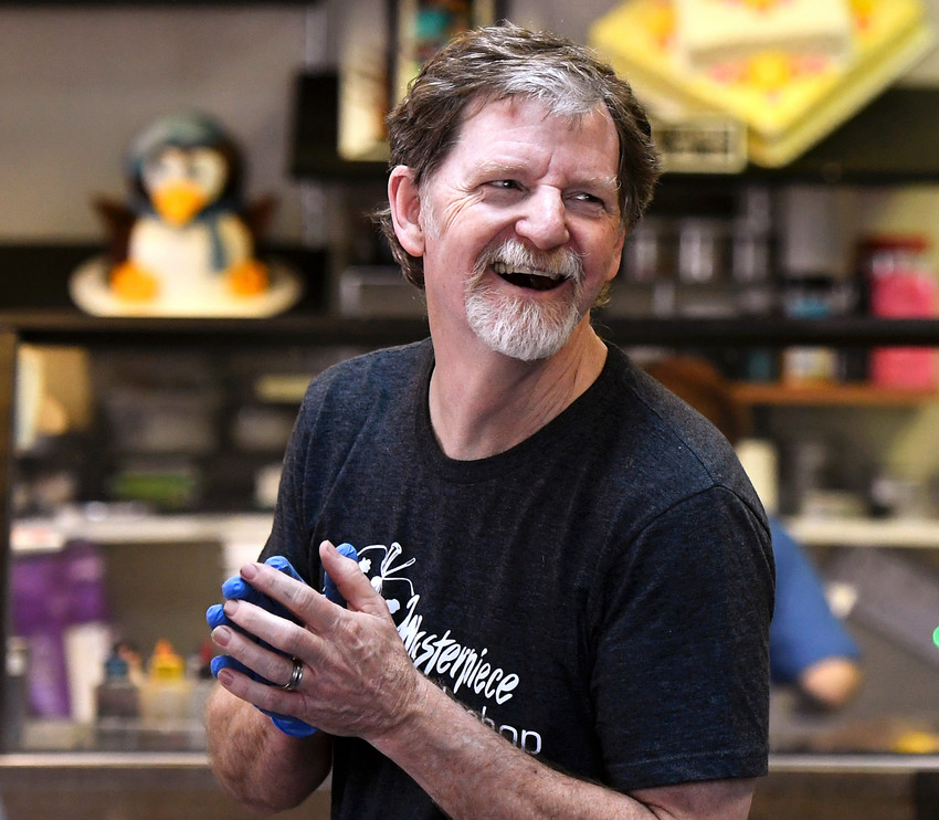 Jack Phillips, owner of the Masterpiece Cakeshop, celebrates in his Colorado store after the U.S. Supreme Court voted 7-2 in his favor in a dispute with a gay couple.