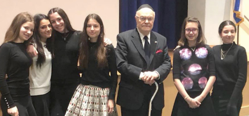 HALB eighth grade girls stand with Jack Rybsztajn, a 93-year-old survivor who lives across the street from the school's new Woodmere campus.