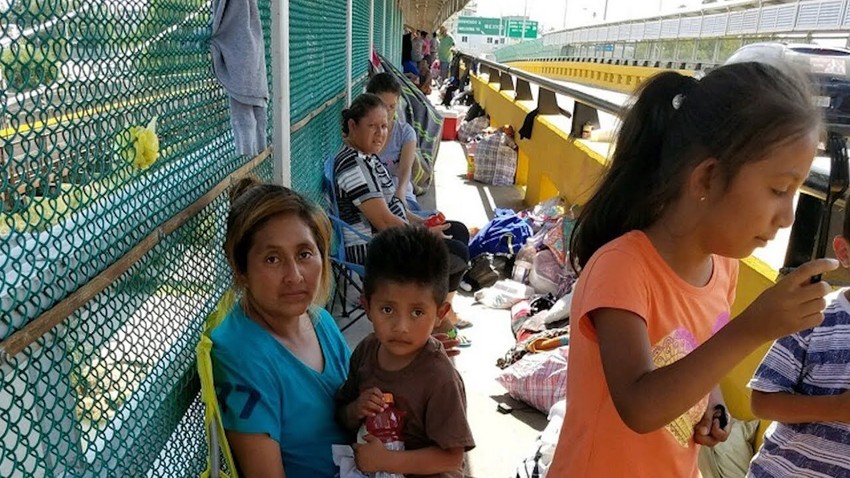 Children with their parents at the U.S.-Mexico border.