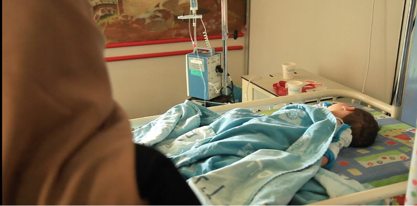 A Syrian mother with her ailing child, who is being cared for at Hadassah&rsquo;s Ein Kerem hospital in Jersualem, in a scene from a video on this unusual undertaking, which can be viewed at bit.ly/2JTyrTV