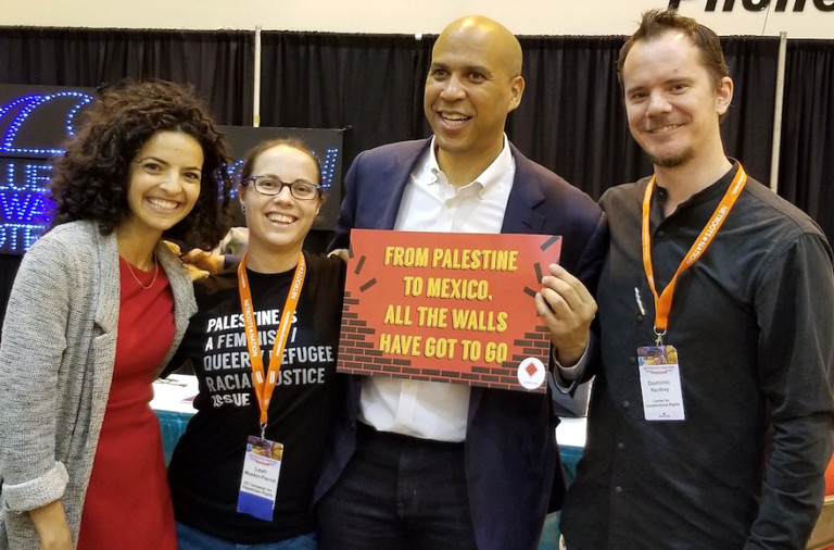 Sen. Cory Booker is shown positing with attendees at the Netroots Nation 2018 conference in New Orleans.