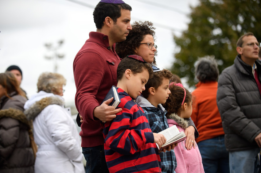 A family pauses in front of at a memorial for victims of the mass shooting that killed 11 people and wounded 6 at the Tree Of Life Synagogue on Oct. 29 in Pittsburgh.
