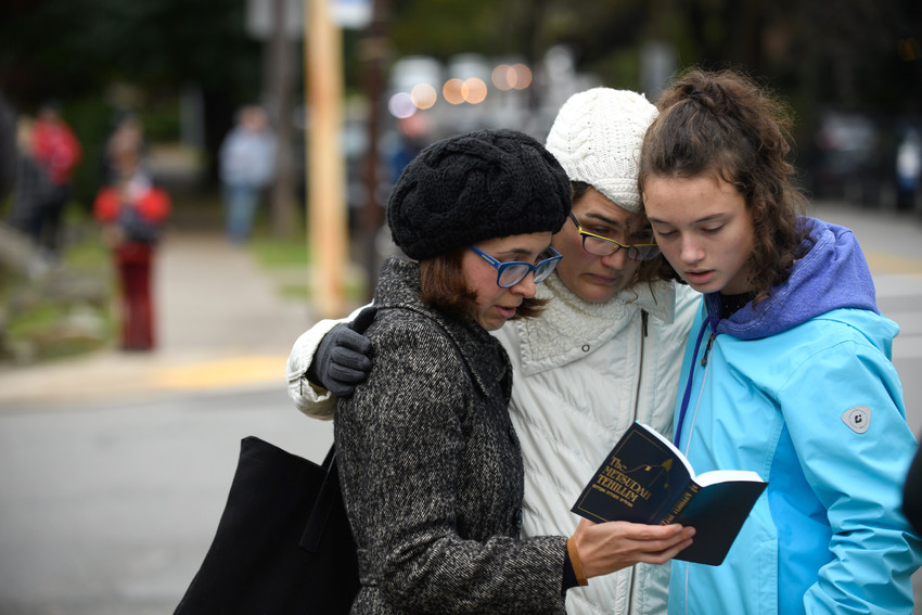 From left: Tammy Hepps, Kate Rothstein and her daughter, Simone Rothstein, 16, pray a block away from the site of a mass shooting at the Tree of Life Synagogue in the Squirrel Hill neighborhood of Pittsburgh, on Oct. 27.