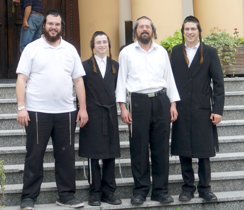 Yossi Blak, left, and fellow travelers from Israel visiting Lublin&rsquo;s Hotel Ilan on Sept. 5.