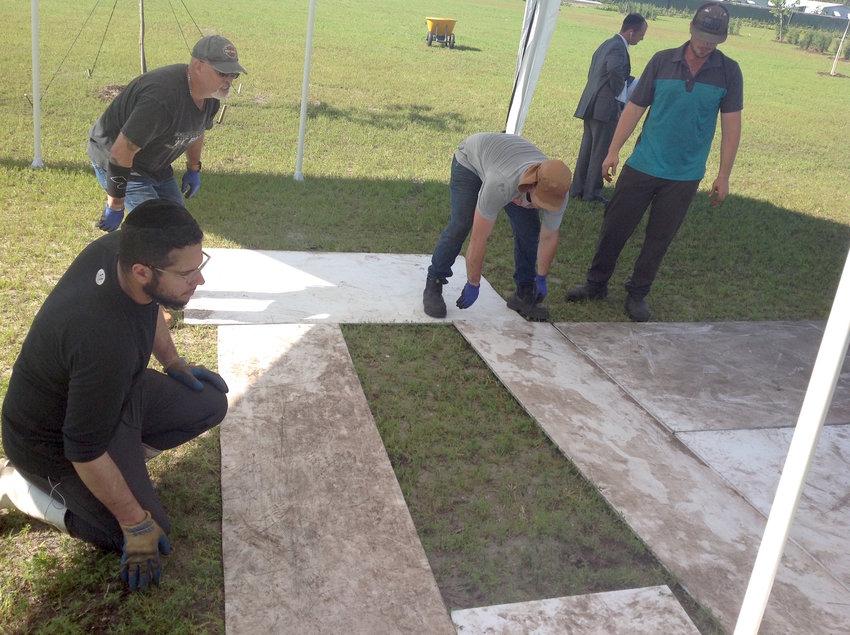 A team of Jewish men prepares a plot for burial at the South Florida Jewish Cemetery earlier this year.