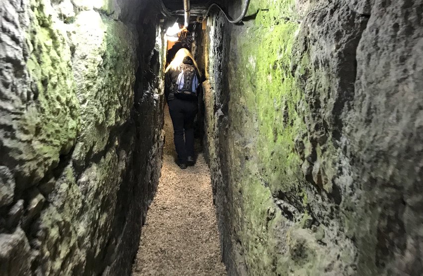 A tourist walks through a portion of Hezekiah&rsquo;s Tunnel.