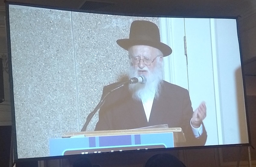 Rabbi Hillel Handler, an anti-vaccination leader, speaks via projection screen to an anti-vaccination rally in an Orthodox Brooklyn venue on June 4.
