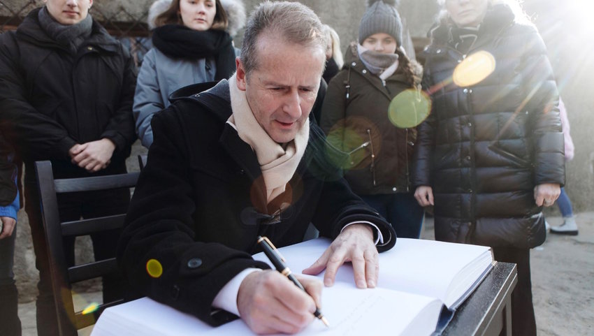 Volkswagen CEO Herbert Diess signs a guest book at Auschwitz, where the company runs an educational program for apprentices.