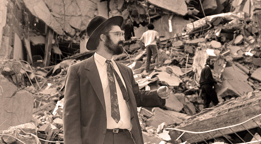 A man walks over the rubble after a bomb exploded at the AMIA Jewish center in Buenos Aires.