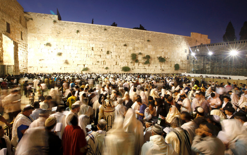 Men gather for Tisha B'Av at the Kotel in the Old City of Jerusalem in the early morning of Aug. 9, 2011.  Tisha B'Av &mdash; which this year begin on Saturday night, July 17 &mdash; is the darkest day in the Jewish calendar, marking the destruction of the two temples, first by the Babylonians in 587 BC and later by the Romans in 70 AD.