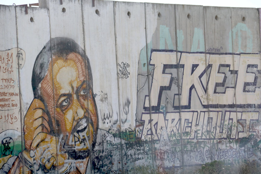 An image of Marwan Barghouti, the Fatah figure serving several life terms in an Israeli prison for murdering civilians, on a separation barrier near Qalandiya in 2016.