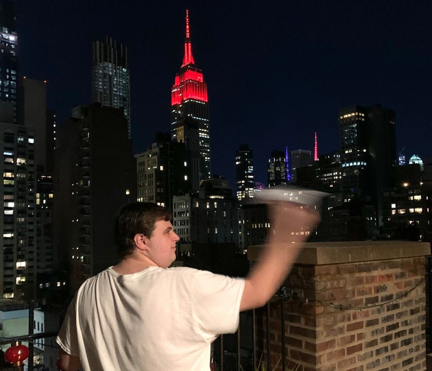 Max Wagenberg launching his paper airplane off his Manhattan terrace.