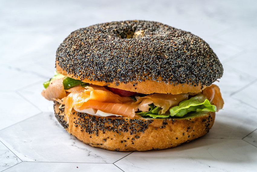Poppyseed bagel with lox and cream cheese.