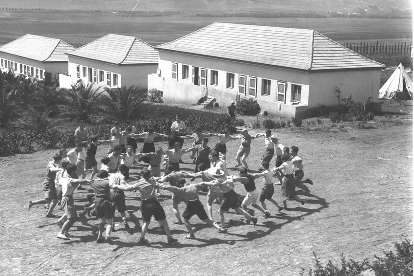 Youth who made aliyah from Germany dance the hora at Kibbutz Ein Harod in 1936.