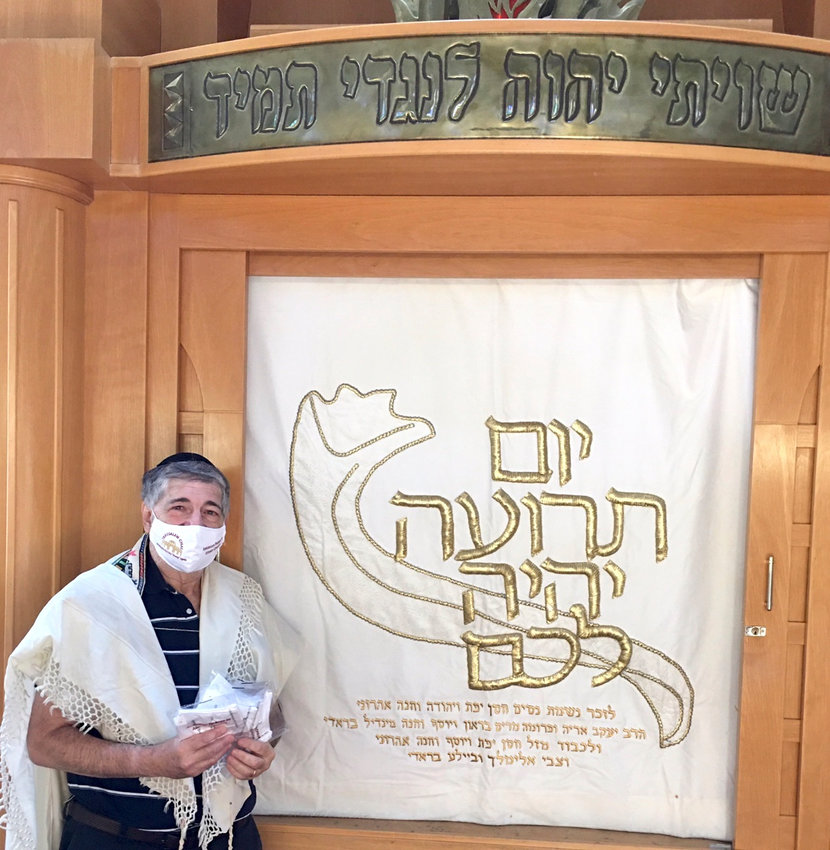 Dr. Paul Brody with Gold Ateret Cohanim masks at the Great Neck Synagogue.