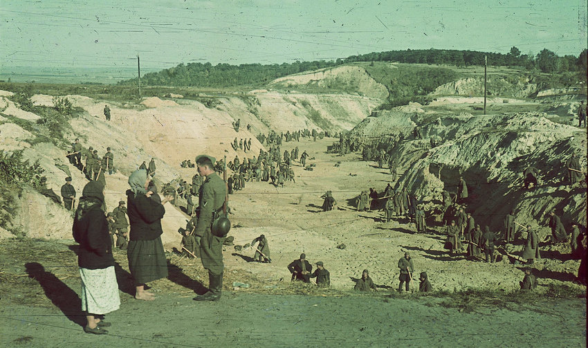 Soviet prisoners of war working under Nazi soldiers bury victims of the Babyn Yar massacre, Oct. 1, 1941.