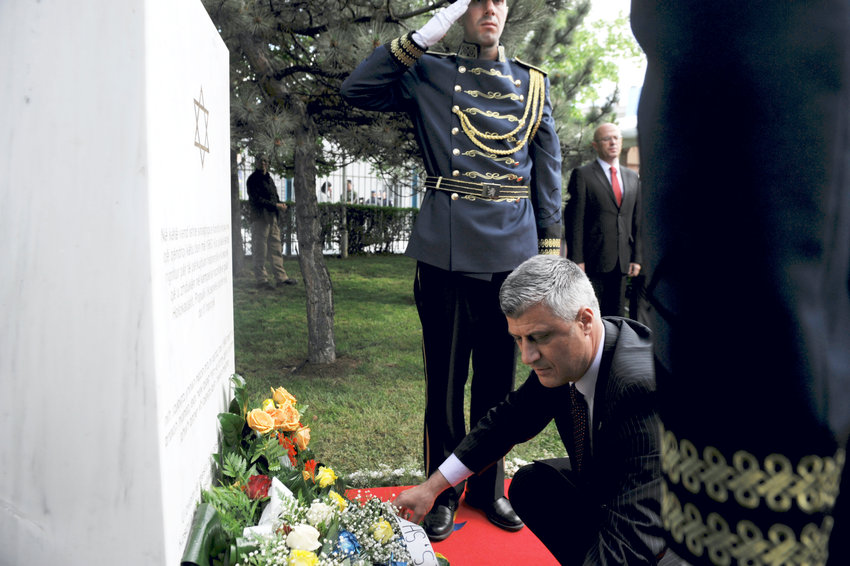Kosovo Prime Minister Hashim Thaci places flowers in Pristina, May 23, 2013, on the commemorative plaque remembering Kosovo Jews who perished in the Shoah, at the site where the last synagogue of Kosovo stood until 1963.