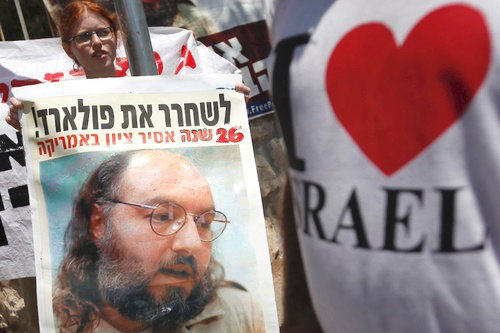 Demonstrators hold signs of Jonathan Pollard as they attend a protest calling for his release outside the house of Israeli President Shimon Peres in Jerusalem, where he met with U.S. congressmen in part to discuss the situation, Aug. 17, 2011.