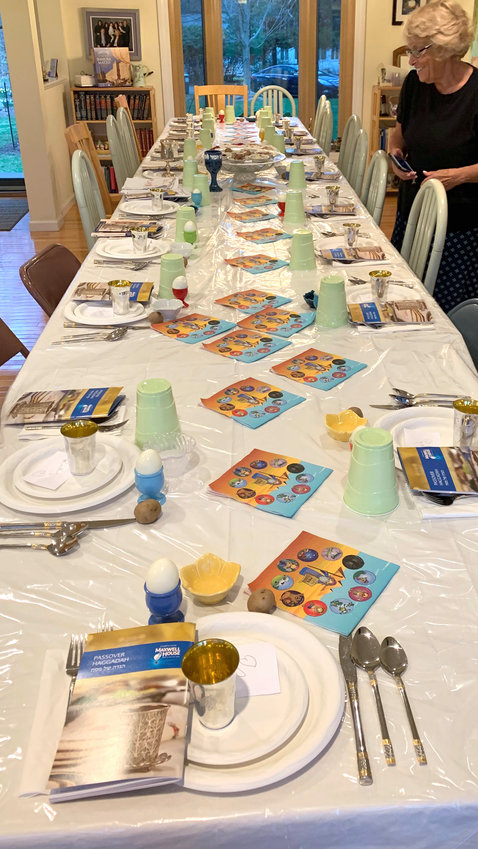 Awaiting guests at a table set for the first seder.