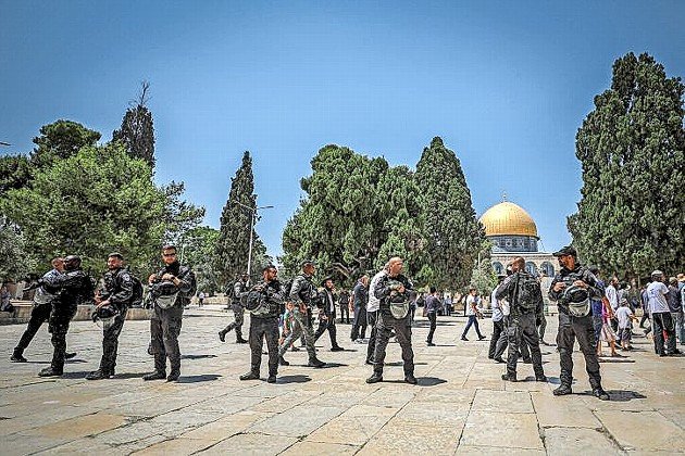Israeli security forces stand guard as a group of Jews visit the Temple Mount during Tisha B'av, July 18.