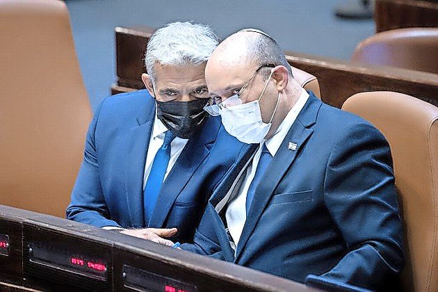 Israeli Foreign Affairs Minister Yair Lapid and Israeli Prime Minister Naftali Bennett during a plenum session in the Knesset on Aug. 2.