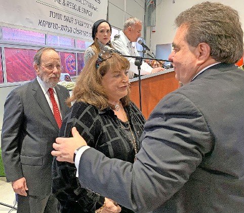 JNF-USA CEO Russell Robinson greets Penny and Stephen Rosen, at the dedication in 2019 of a fire station in the northern Jewish-Arab city of Ma&rsquo;alot Tarshiha, in memory of the Rosen&rsquo;s son Adam.