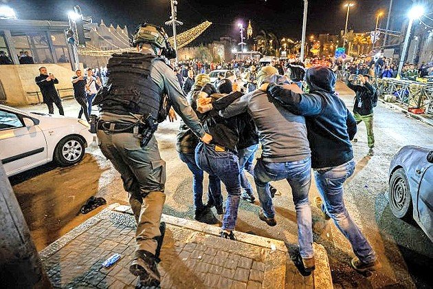 Israeli undercover police officers arrest a man during clashes with protesters at Damascus Gate in Jerusalem's Old City, during Ramadan on April 3.