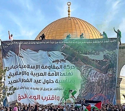 At the golden-topped Dome of the Rock, Palestinians wave flags of Palestine and hold a large Hamas banner reading, &ldquo;Jerusalem isn&rsquo;t for sale,&rdquo; while celebrating Eid Al-Fitr on May 2.