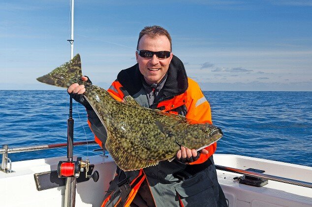 Fisherman (not Joni&rsquo;s father, who usually caught flounder) snags a halibut.
