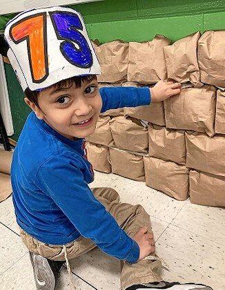 A student in Chavatzelet Graber&rsquo;s CAHAL kindergarten class at HANC wears a special birthday hat as he puts a note into the &ldquo;Kotel.&rdquo;