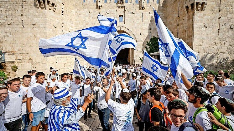 Dancing with Israeli flags, Jews celebrate at the Damascus Gate in the Old City, on Jerusalem Day, May 29, 2022